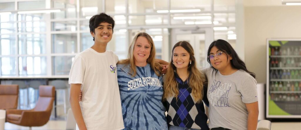 Group of South Piedmont students posing for a photo inside the student center.