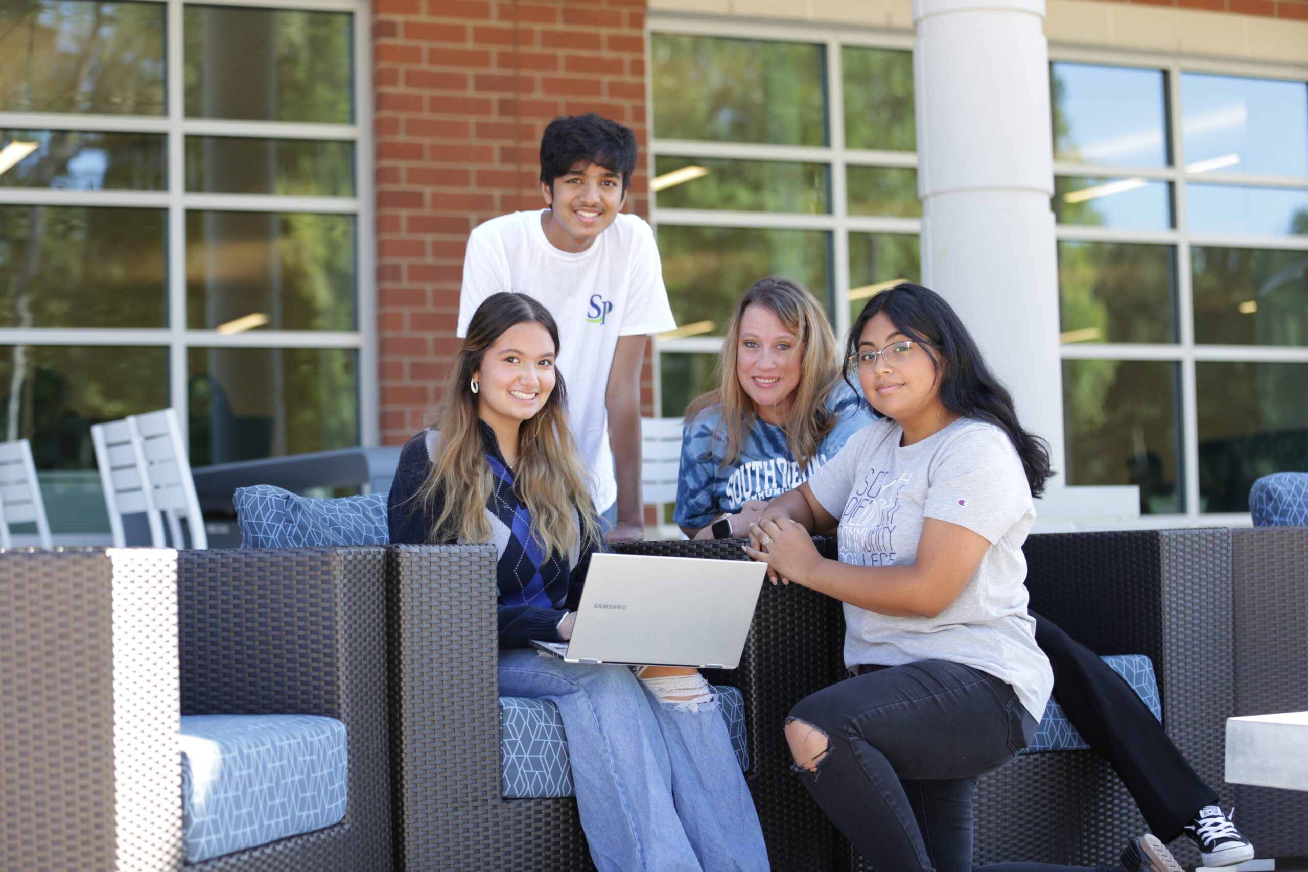 Photo of a group of students at a table on the patio at South Piedmont.