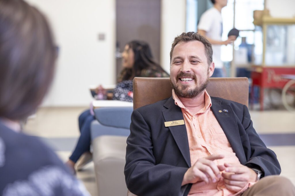 South Piedmont staff member smiling while talking to a student.