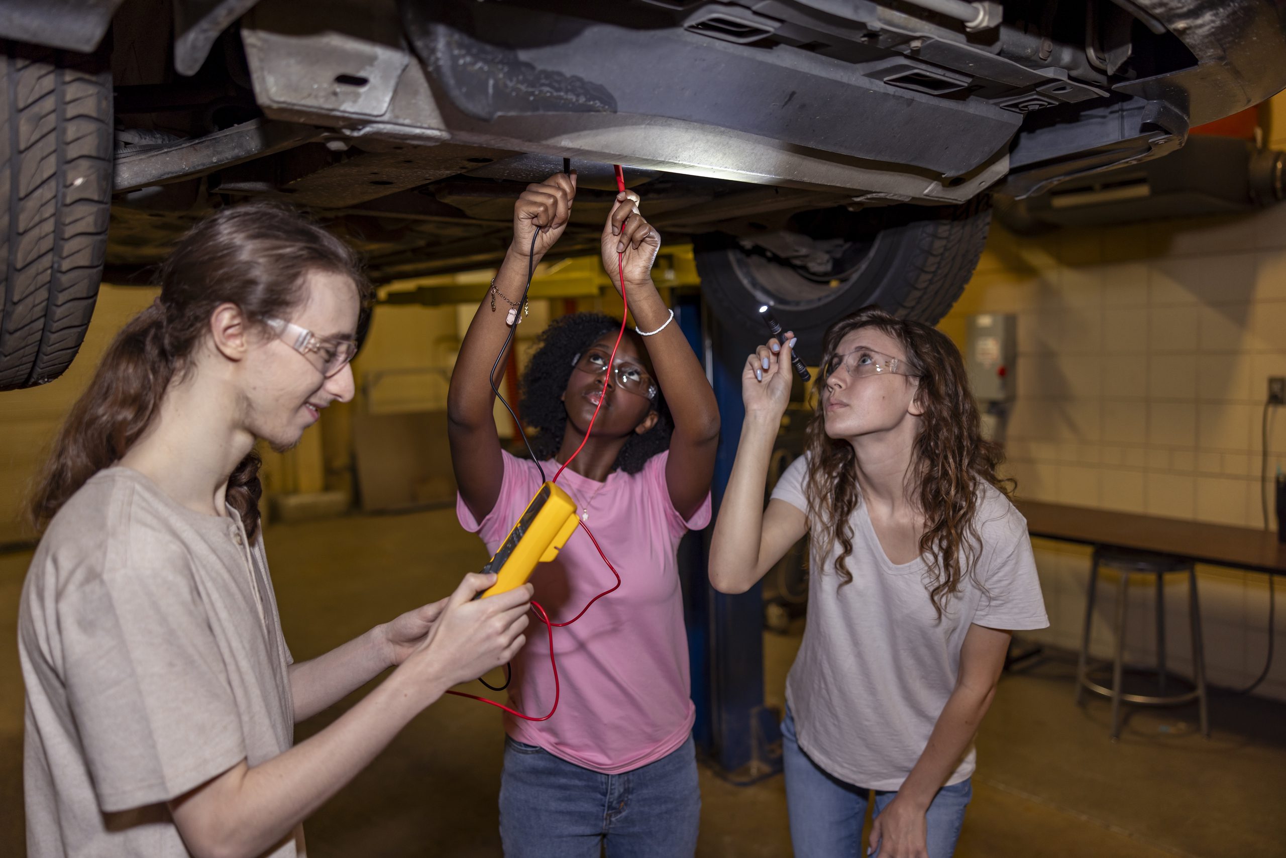 Students working under a car.