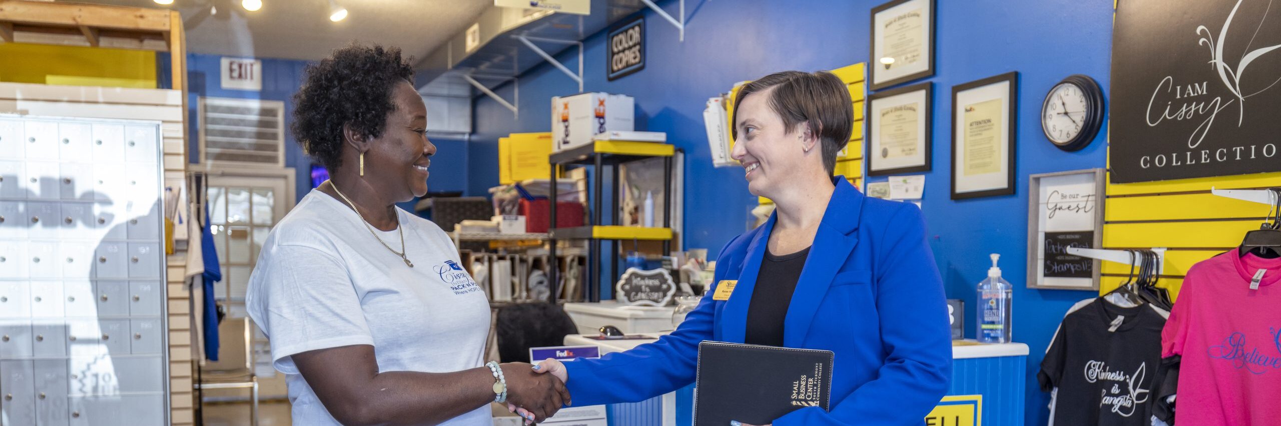 South Piedmont representative shaking hands with Cissy's pack N post owner.