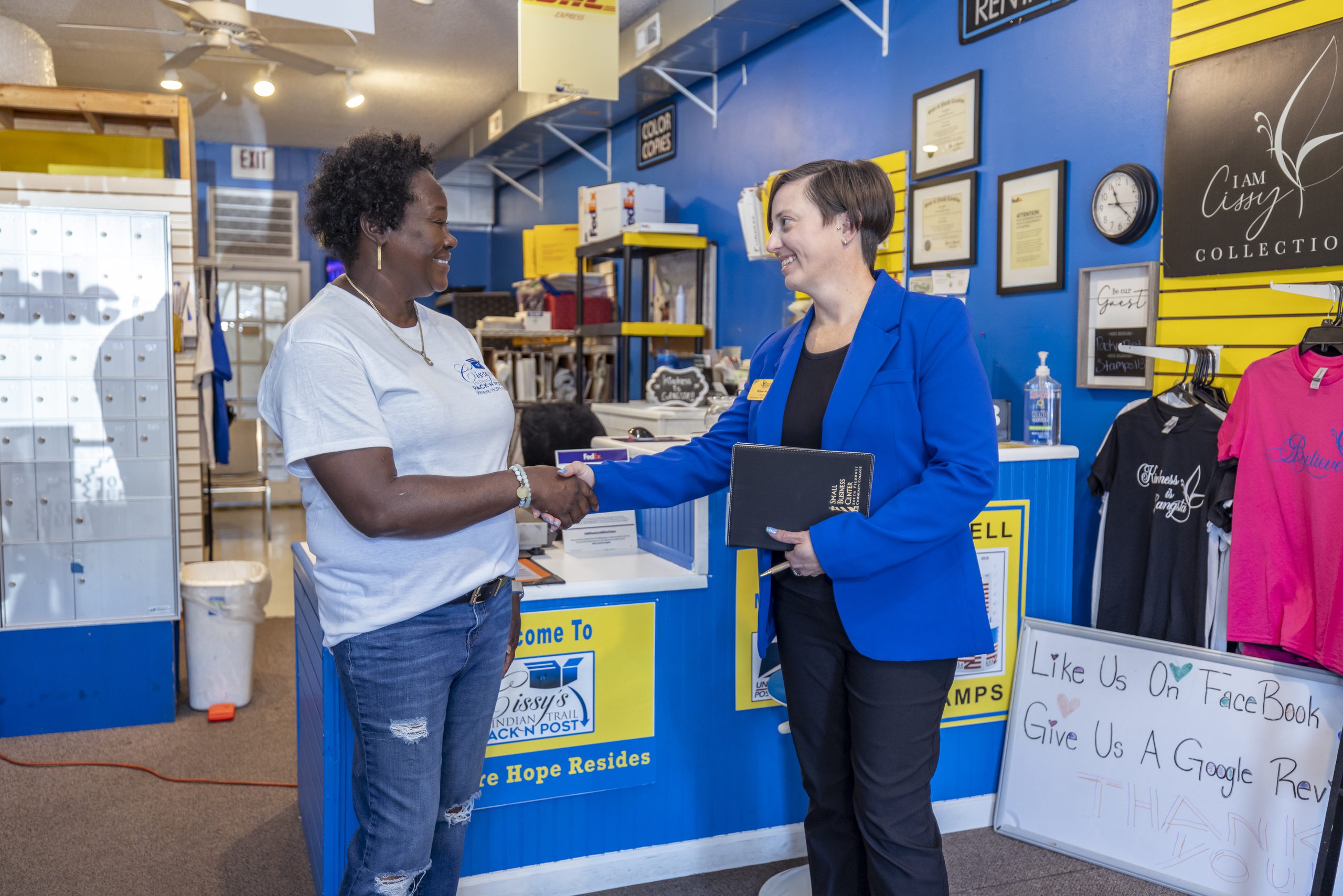 South Piedmont representative shaking hands with Cissy's Pack N Post owner