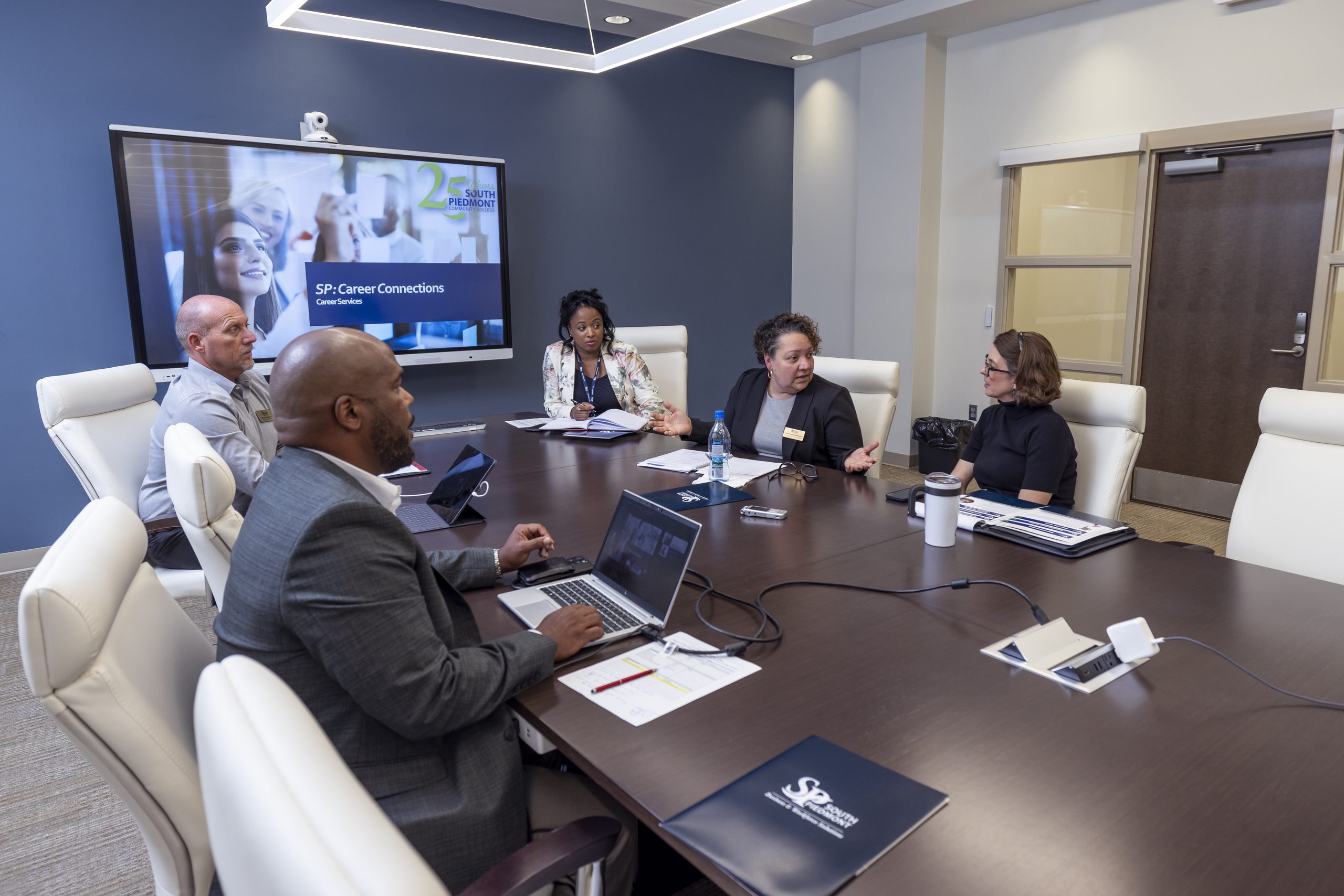 Business & Workforce Solutions members having their meeting.