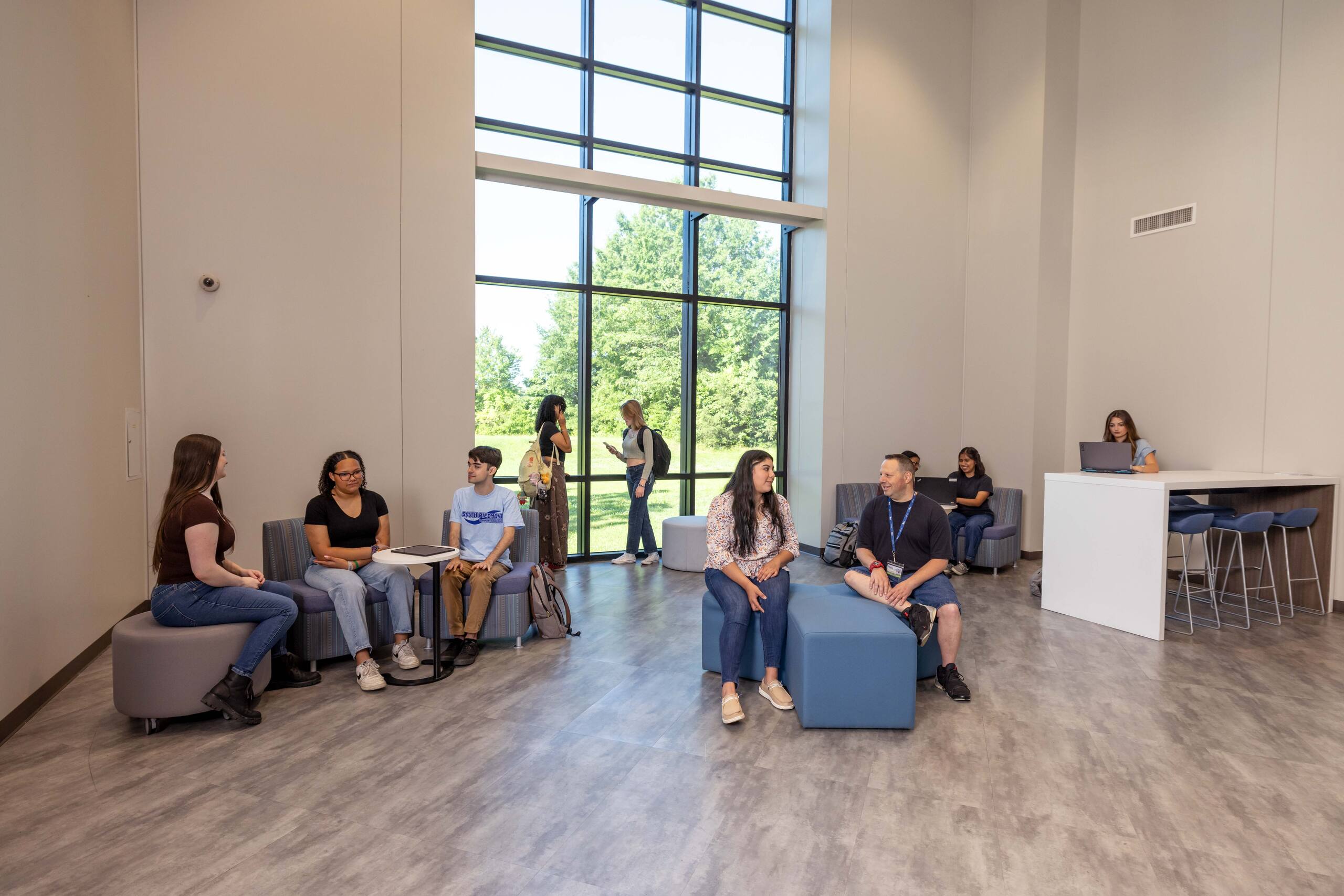 Group of students gathered around in a lounge area.