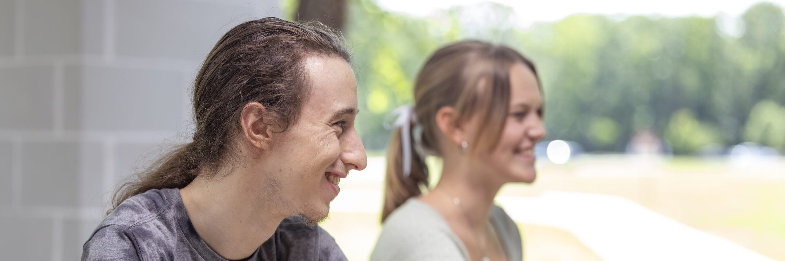 Two students sitting outdoors.