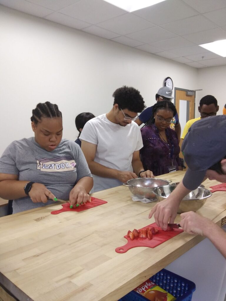 Group of students learning culinary skills through the Food Service Academy.