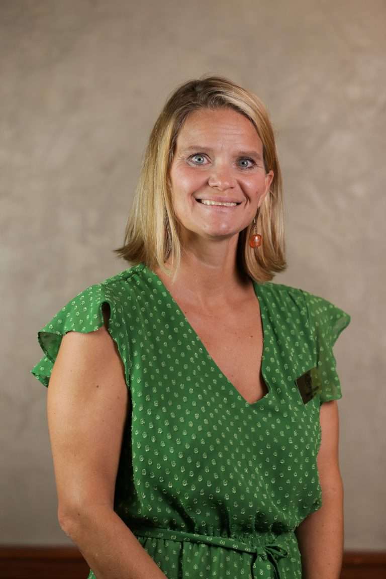 Photo of a woman in a green dress.