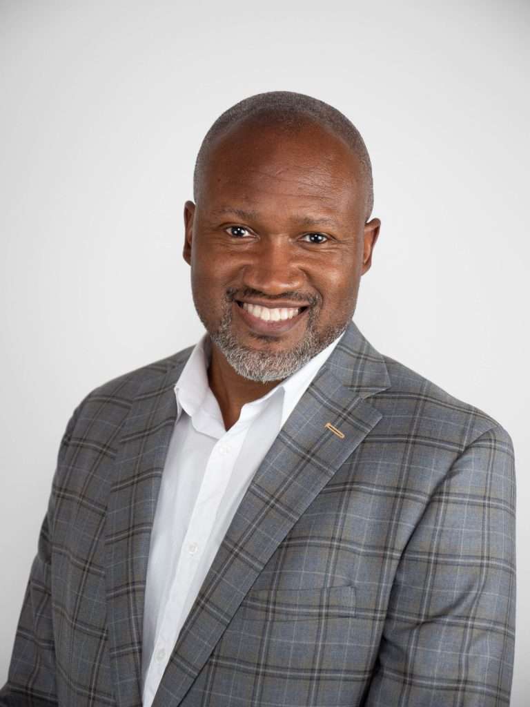 Photo of a man in a grey shirt.