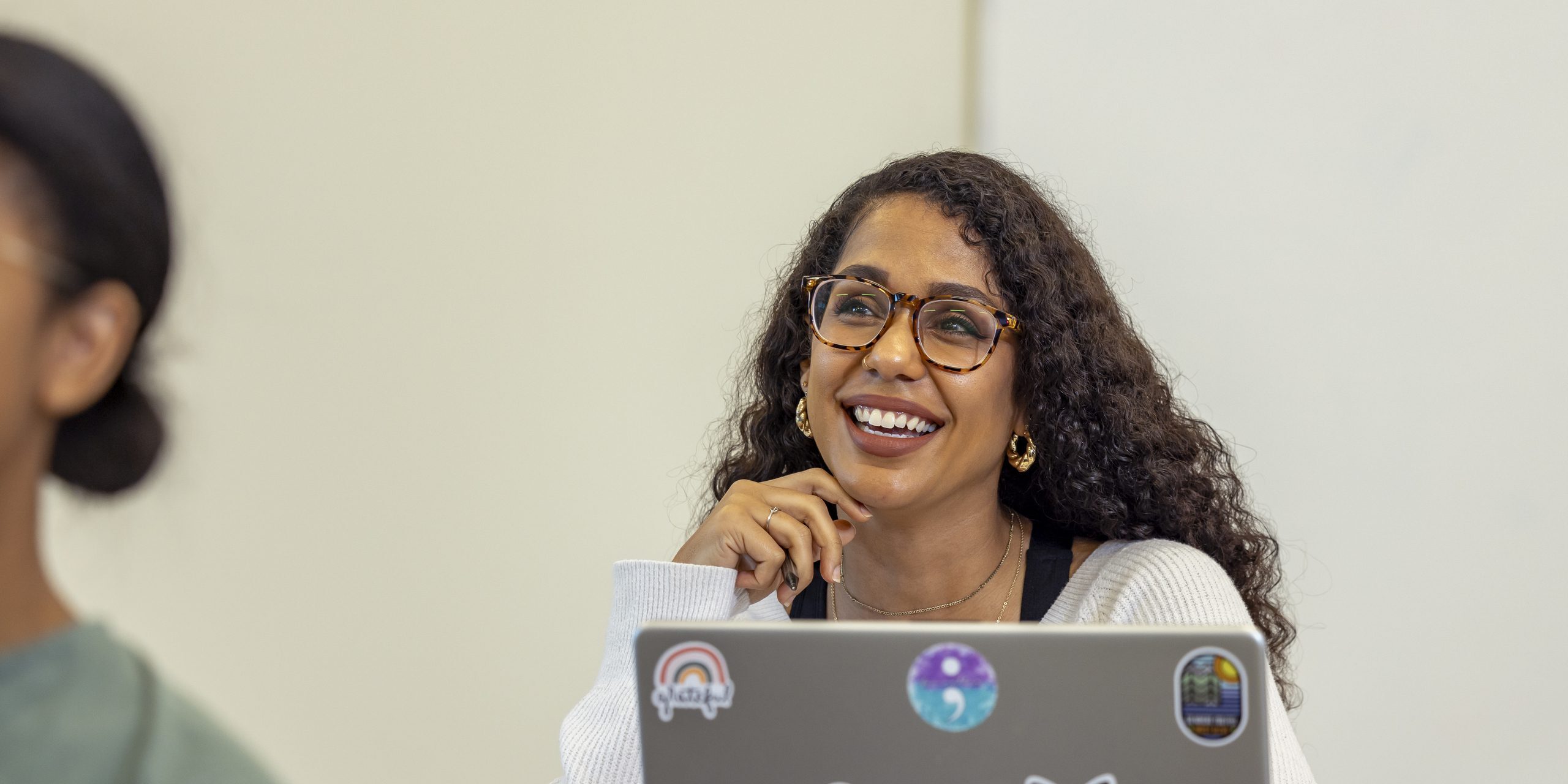 A female student smiling and looking to her right.