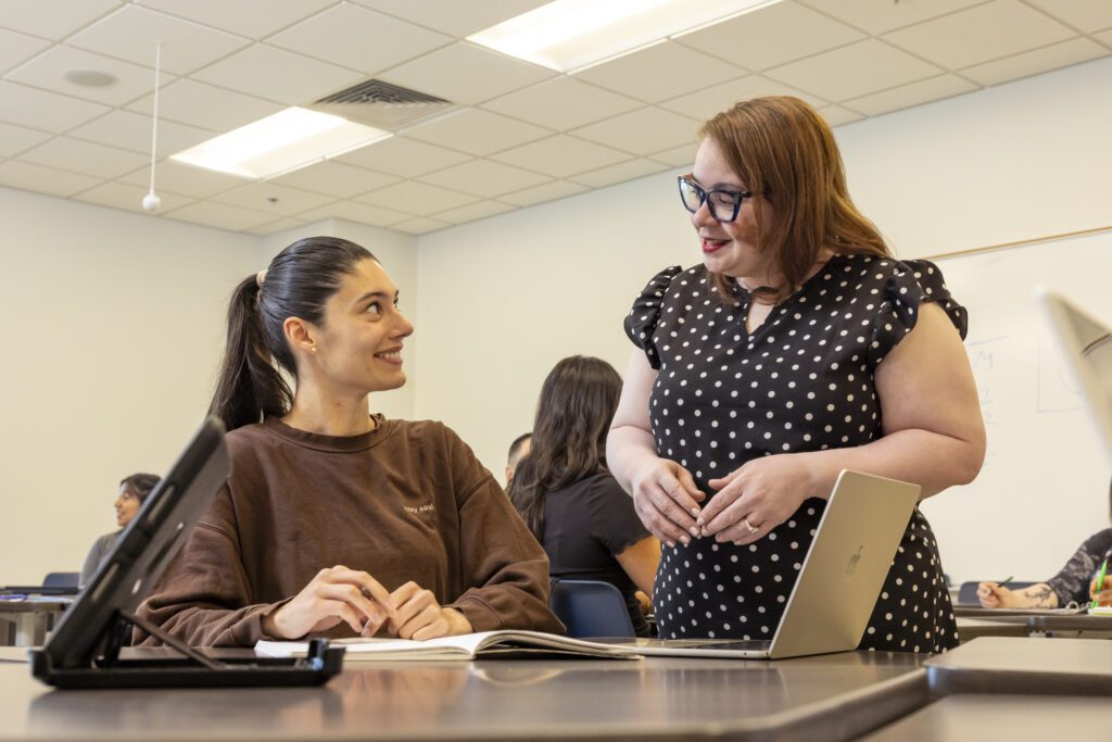 Teacher and student in a classroom setting.