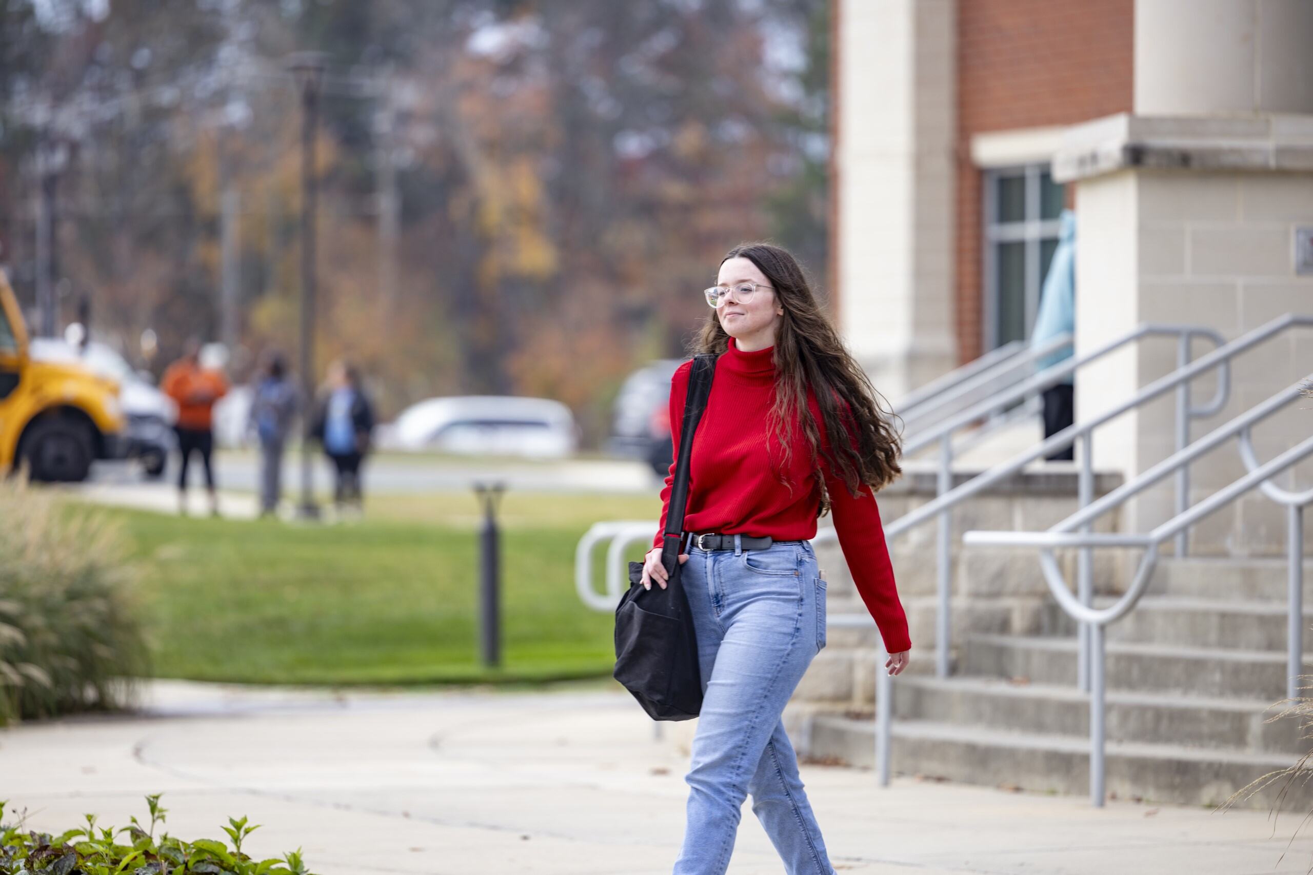 Student walking outside of the Main Building.