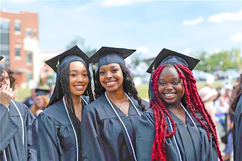 Three female graduates at South Piedmont's commencement ceremony.