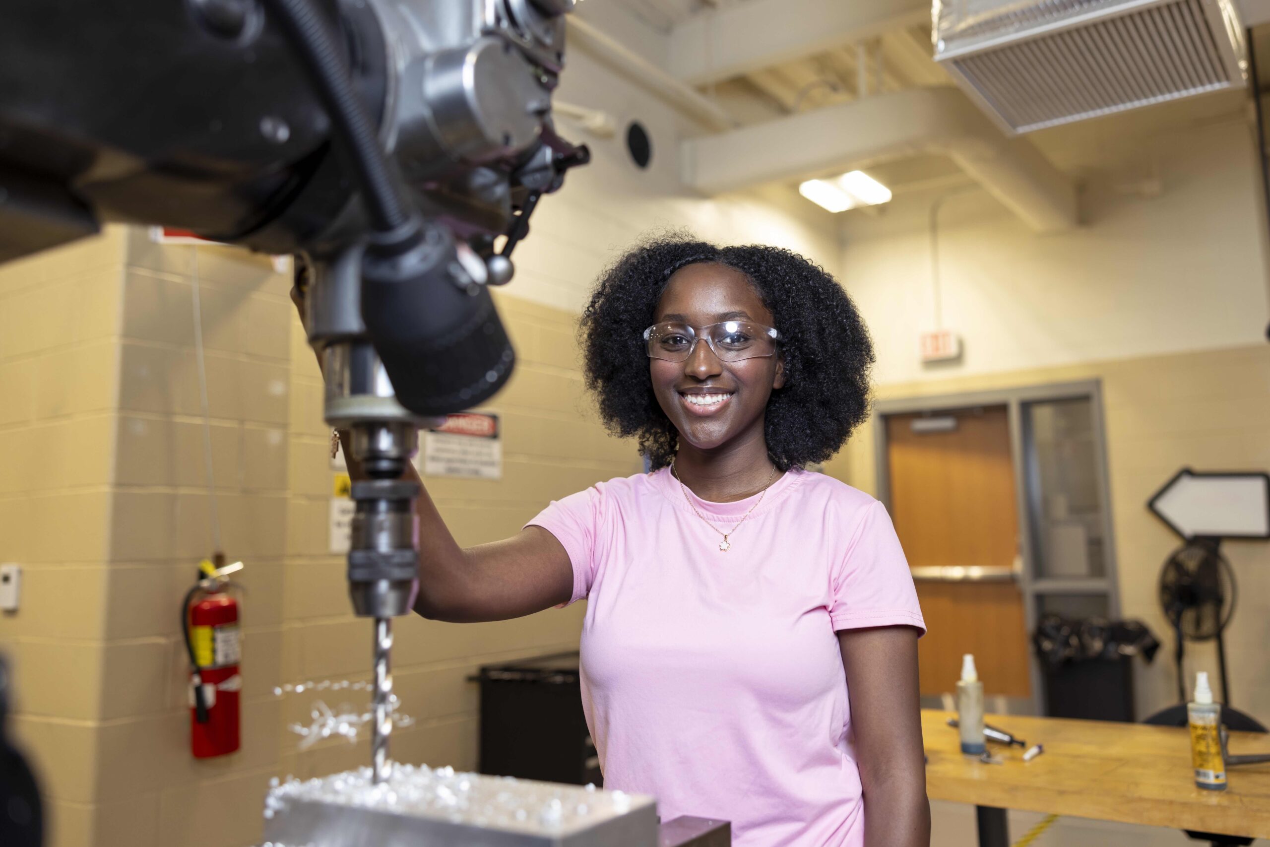 Industrial Systems Technology student handling a drilling machine.