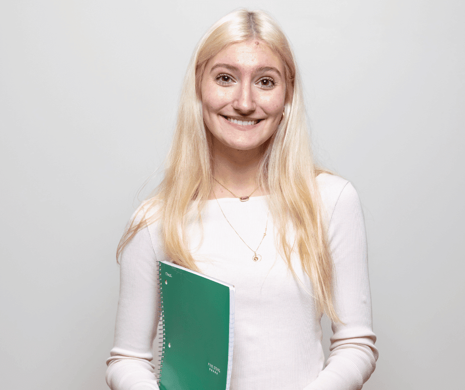 Photo of a white female student smiling at the camera.