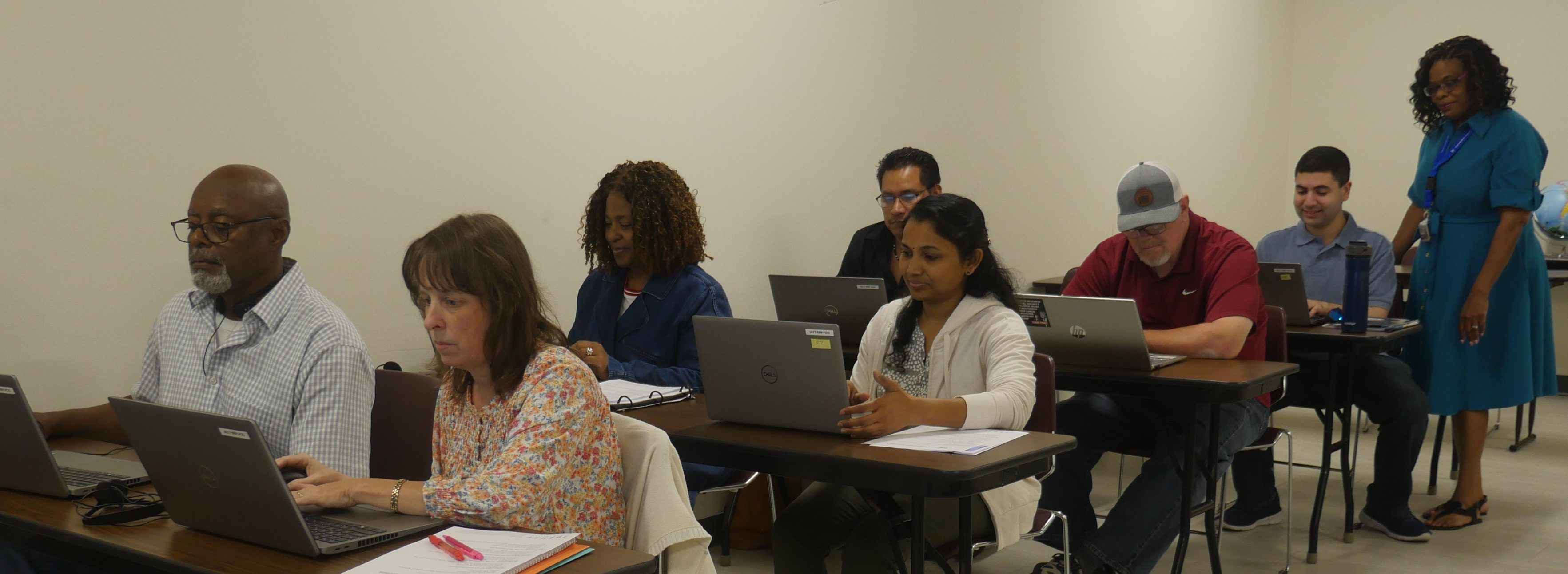 Digital Literacy students inside a classroom, all looking at their laptop.