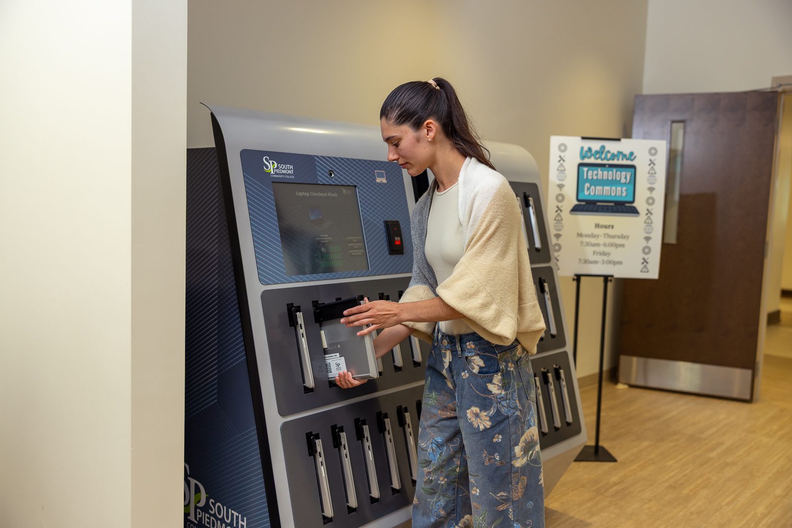 Student using a laptop kiosk machine at the Technology Commons.