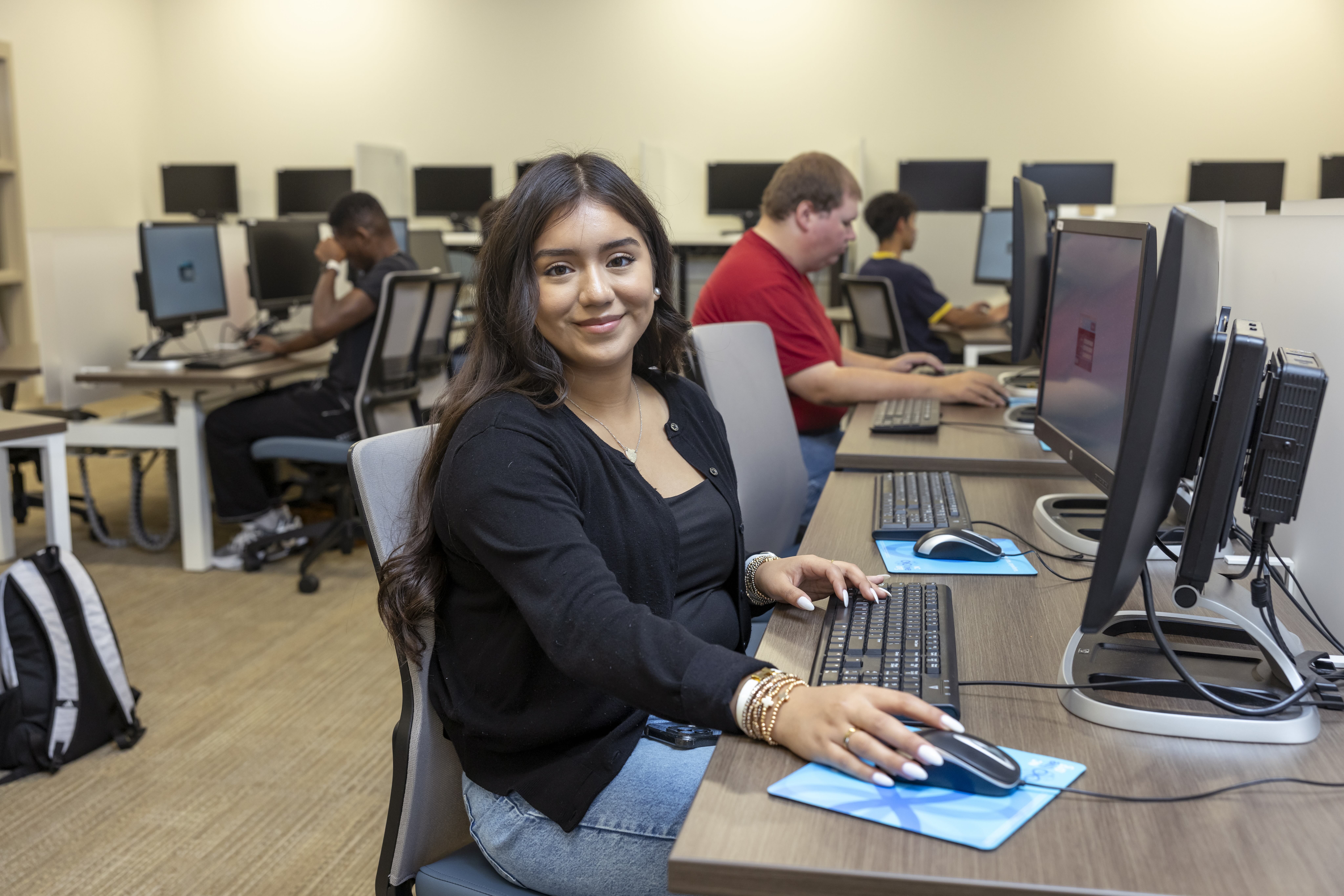 A female student working in a computer lab.
