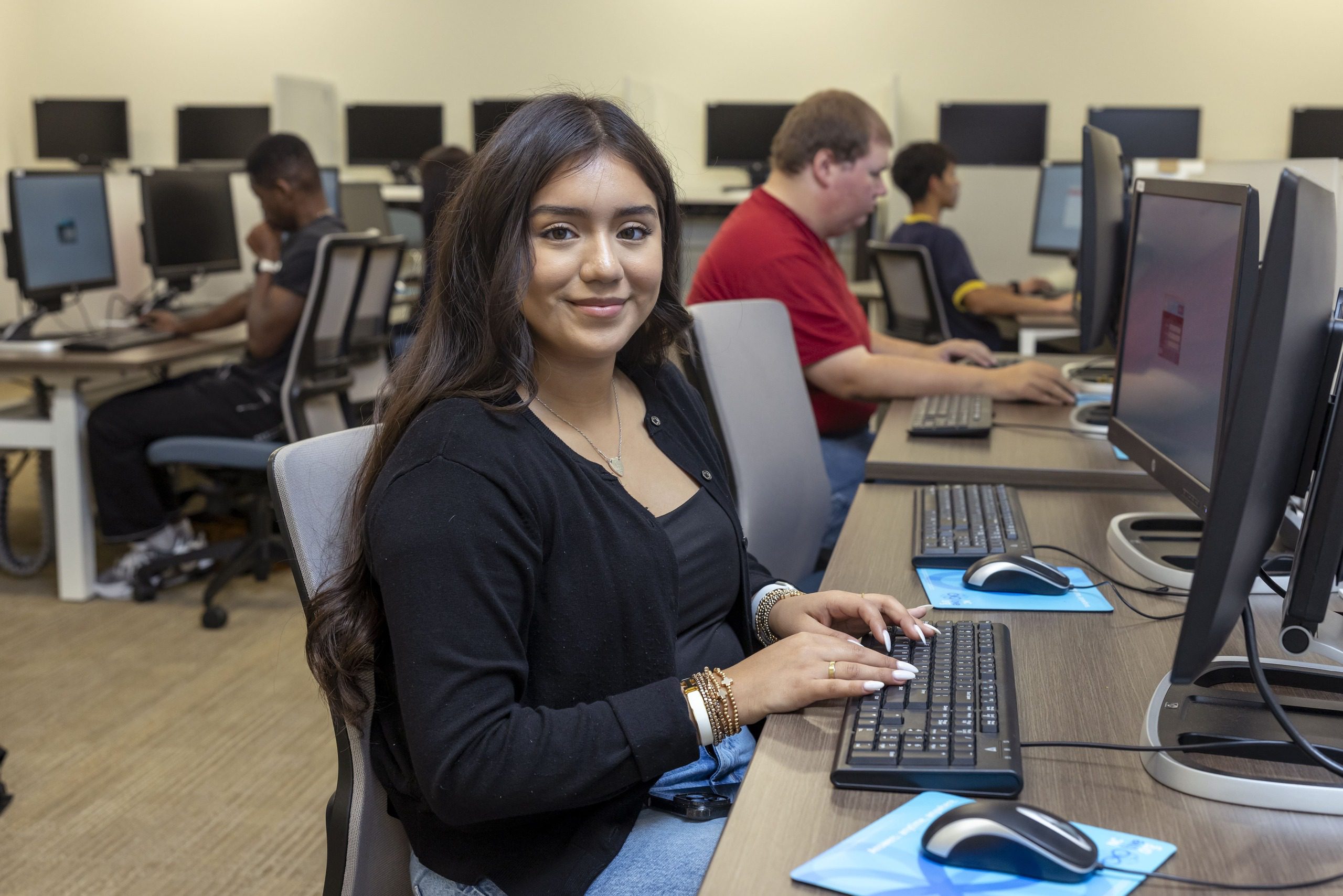 Student sitting in front of a computer in a South Piedmont computer lab.