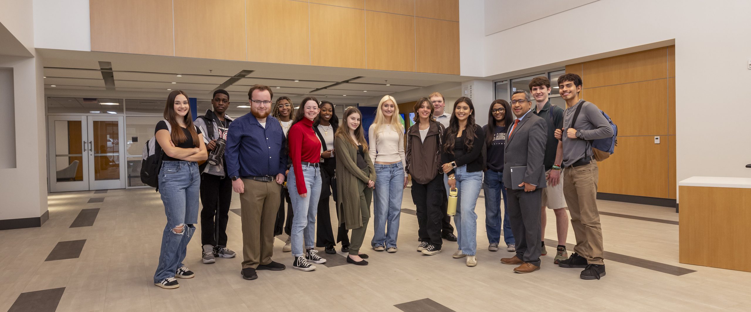 Group of students gathered around the main entrance of Building A.