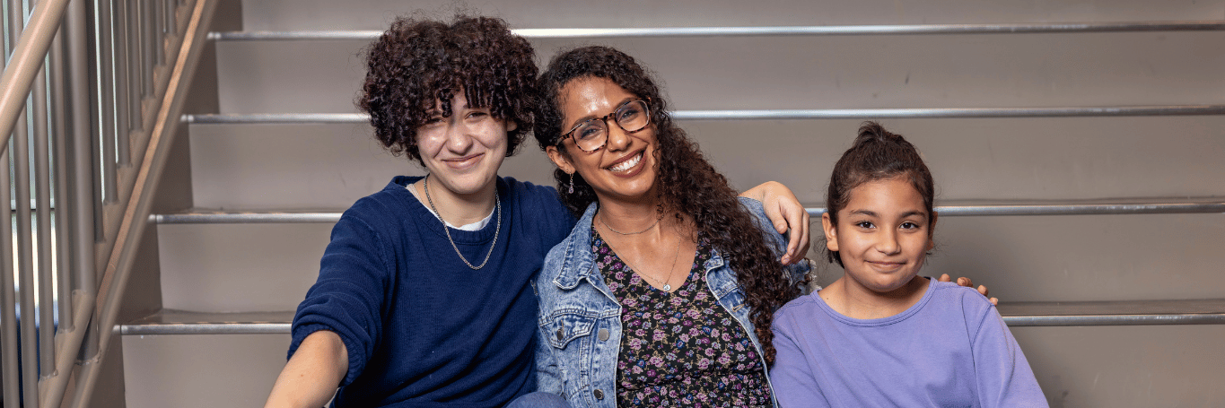 Adult student with her children, smiling.