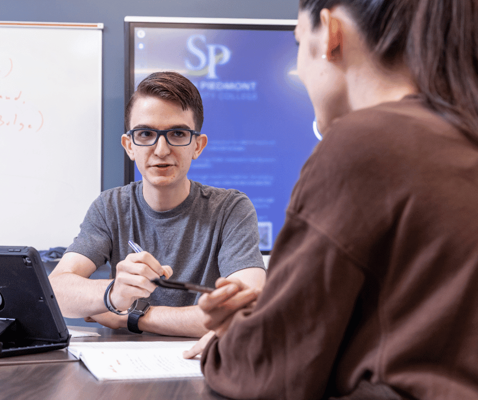 Photo of a male student in class.