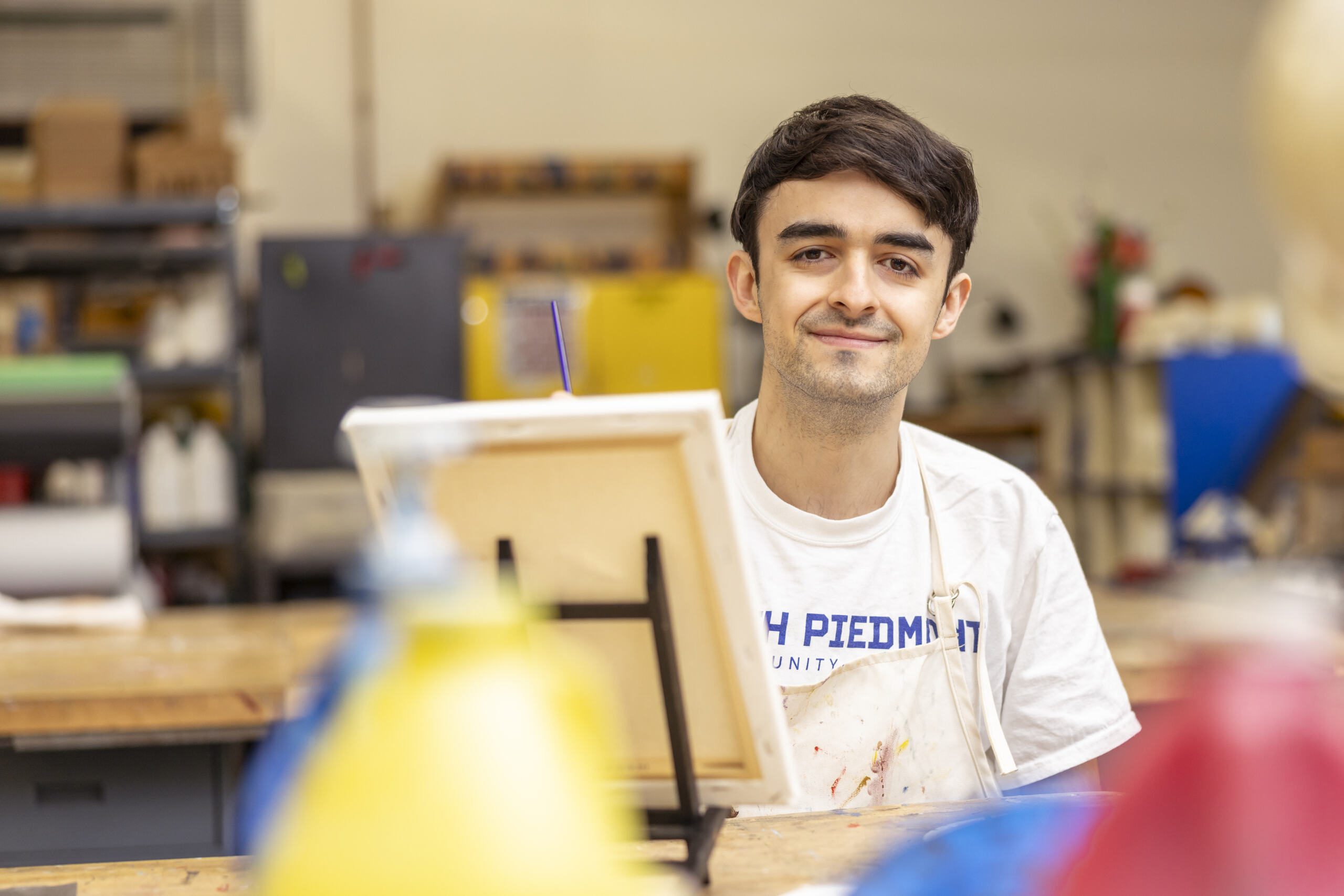 Student in front of an easel.