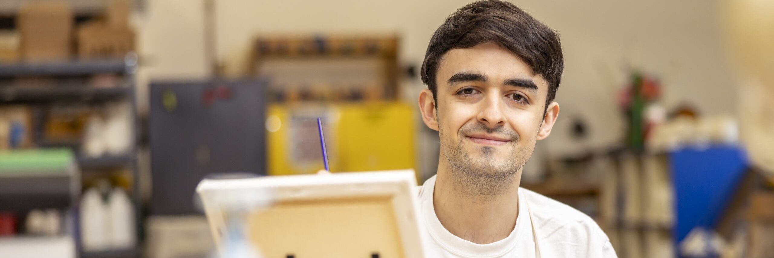 Student in front of an easel.