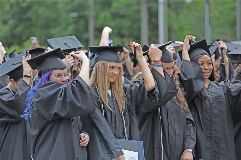 Graduates moving their tassels at a South Piedmont commencement ceremony.