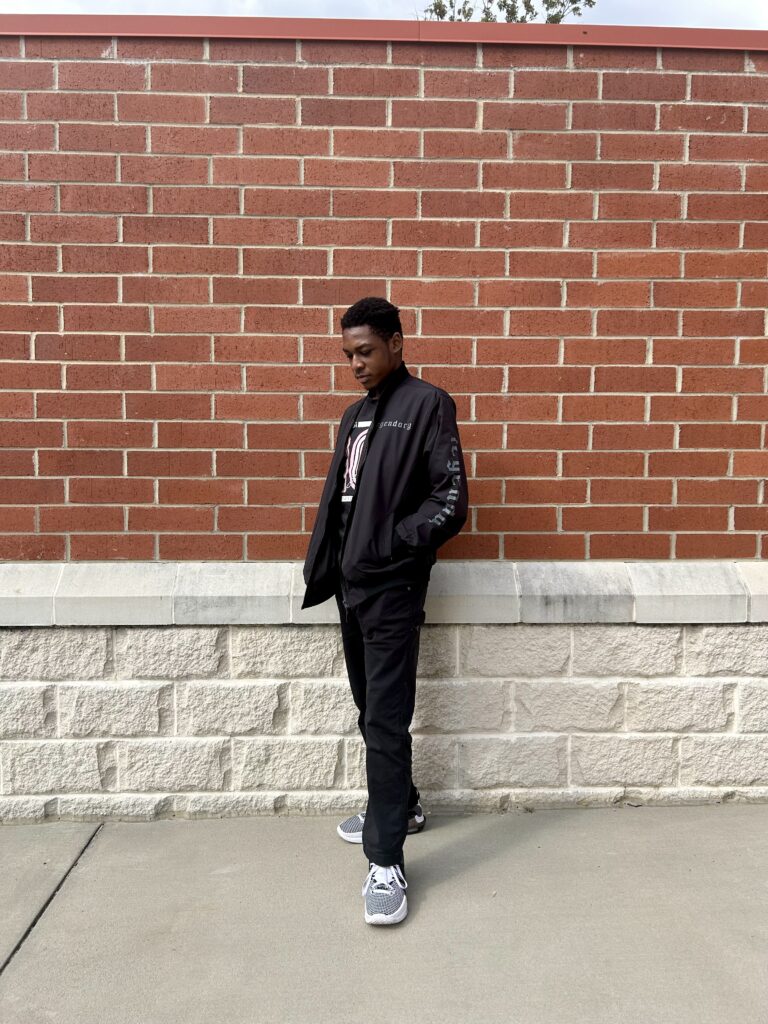 South Piedmont student Jaylen Harrison in front of a red brick wall.