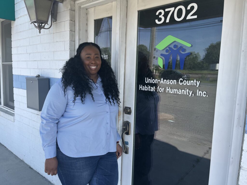 Keturah Key in front of the Union-Anson County Habitat for Humanity building.