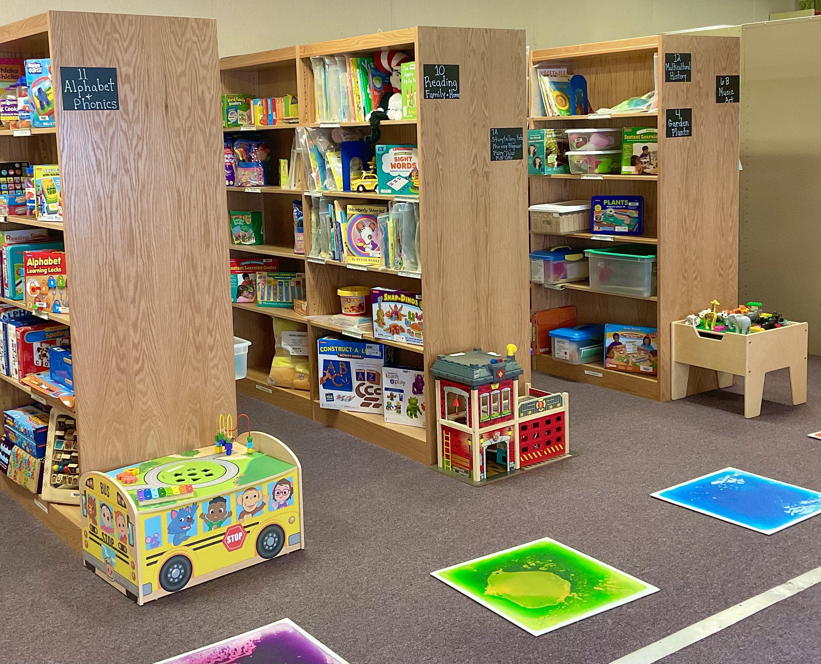 Photo of shelves containing books, games, and other early childhood resources available at the Smart Start Resource Center.