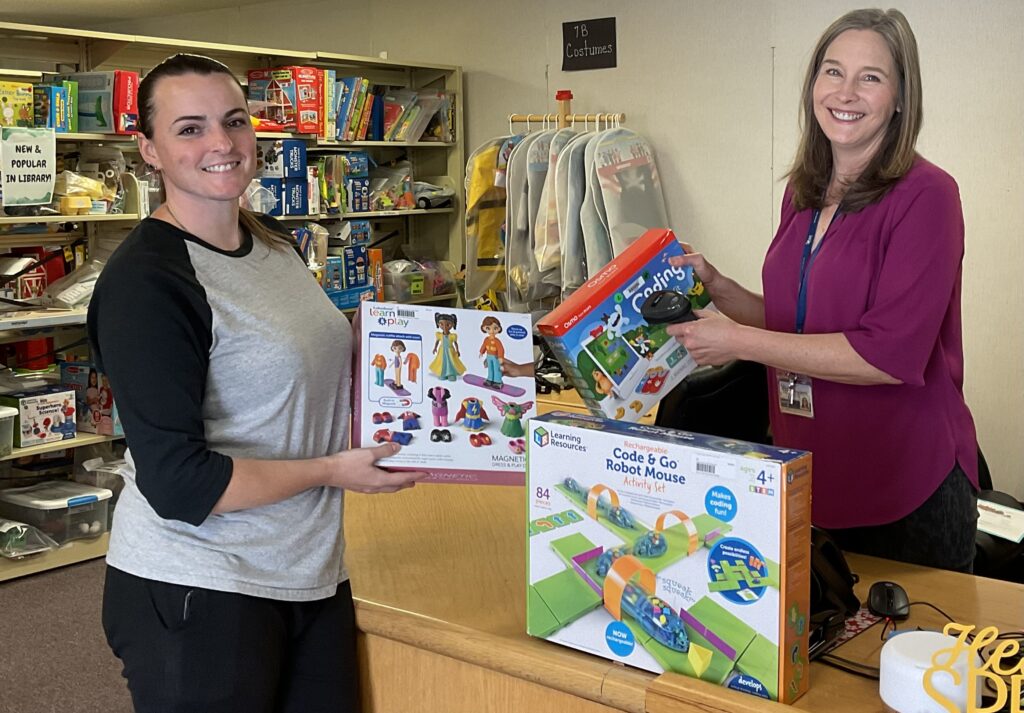 Photo of a Smart Start Resources Center staff member helping a patron.