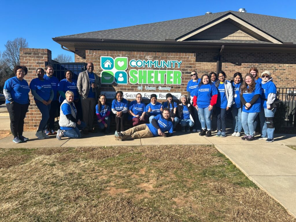 A group of people gathered outside a local nonprofit agency after having volunteered during the MLK Day of Service.