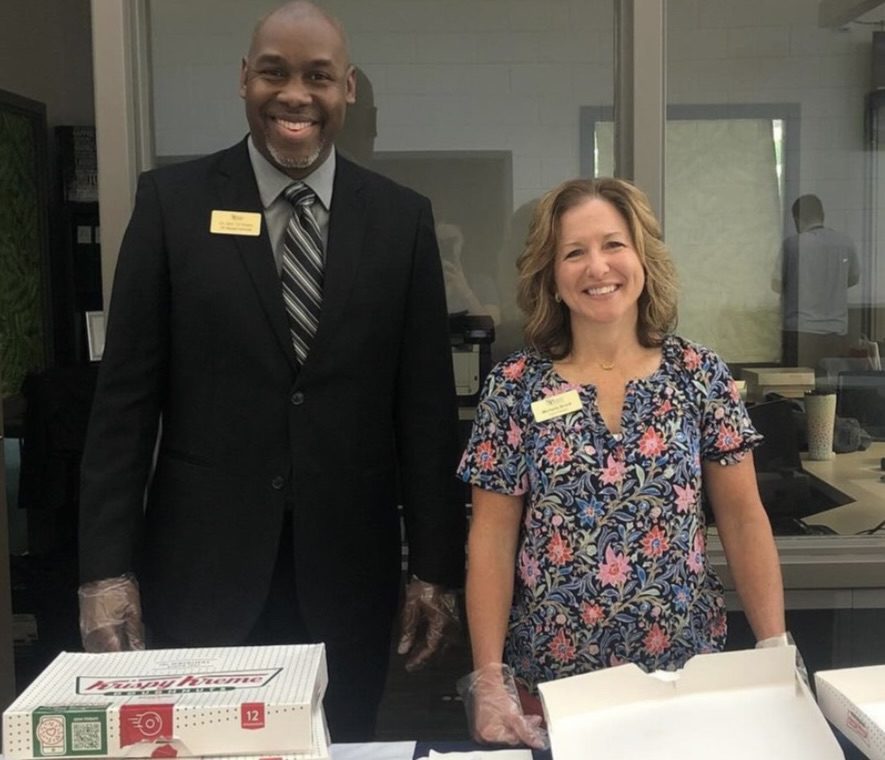 Photo of Vice President for Academic Affairs Dr. JJ Evans and Interim President Michelle Brock with boxes of donuts.