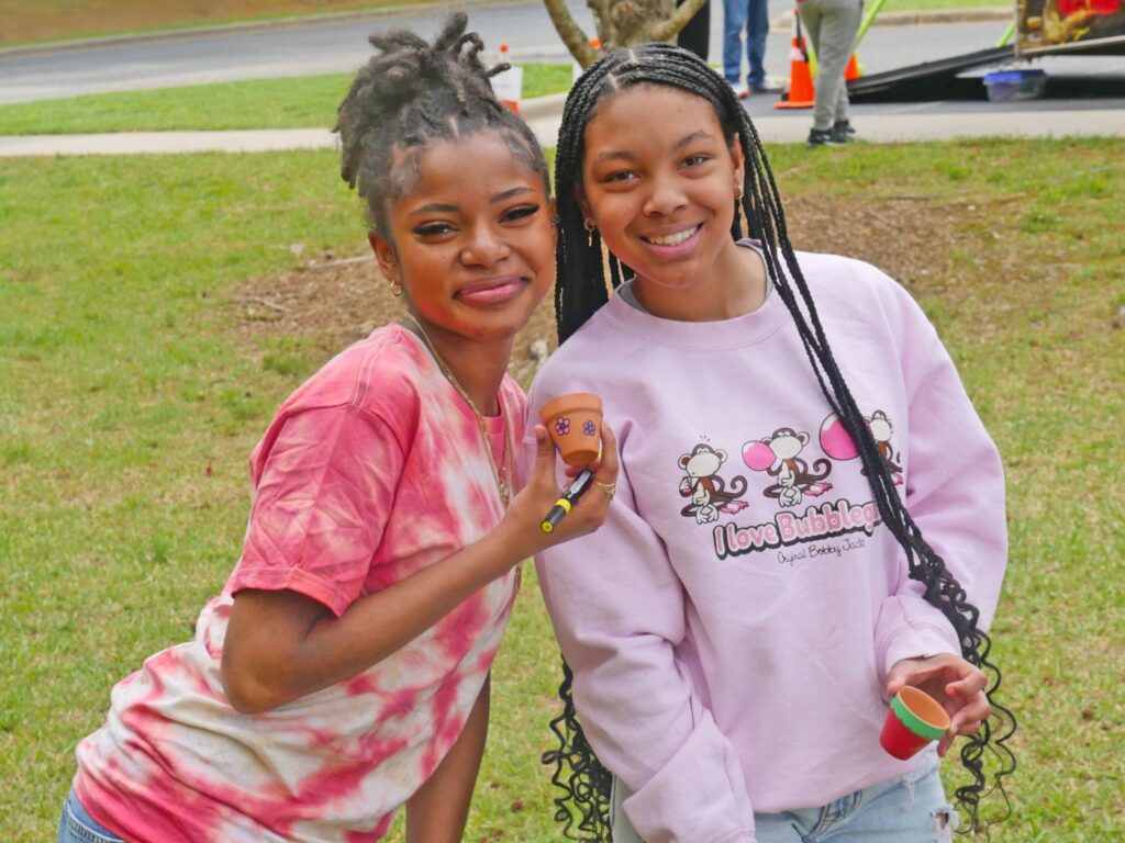 Two girls in pink shirts participating in Spring Fling at South Piedmont's L.L. Polk Campus.