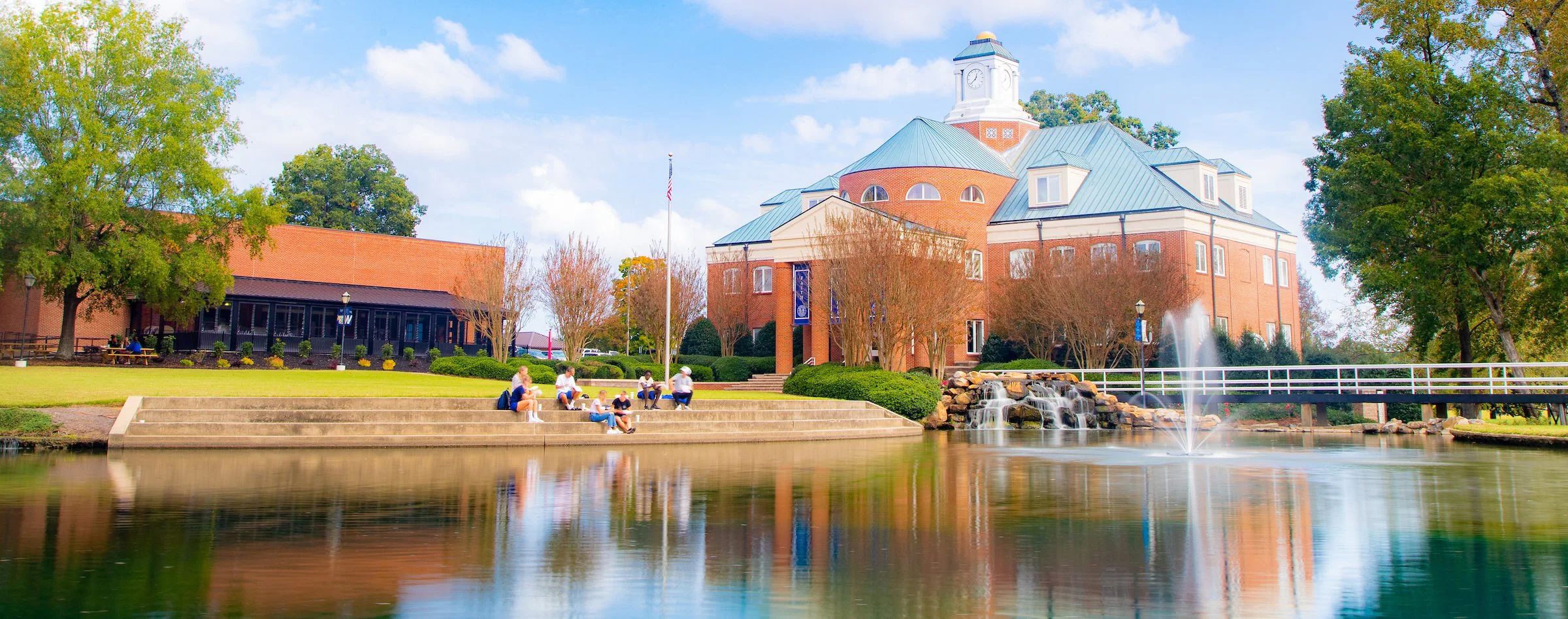 Wingate University Stegall Building with a lake in front.