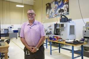 A man standing in South Piedmont's machining lab.