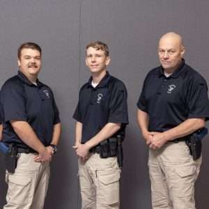 Image of three male law enforcement students looking at the camera.