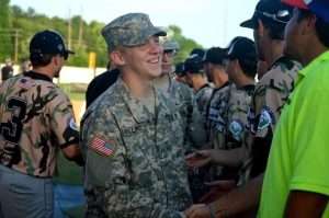 A man in a military uniform shaking hands with another man.