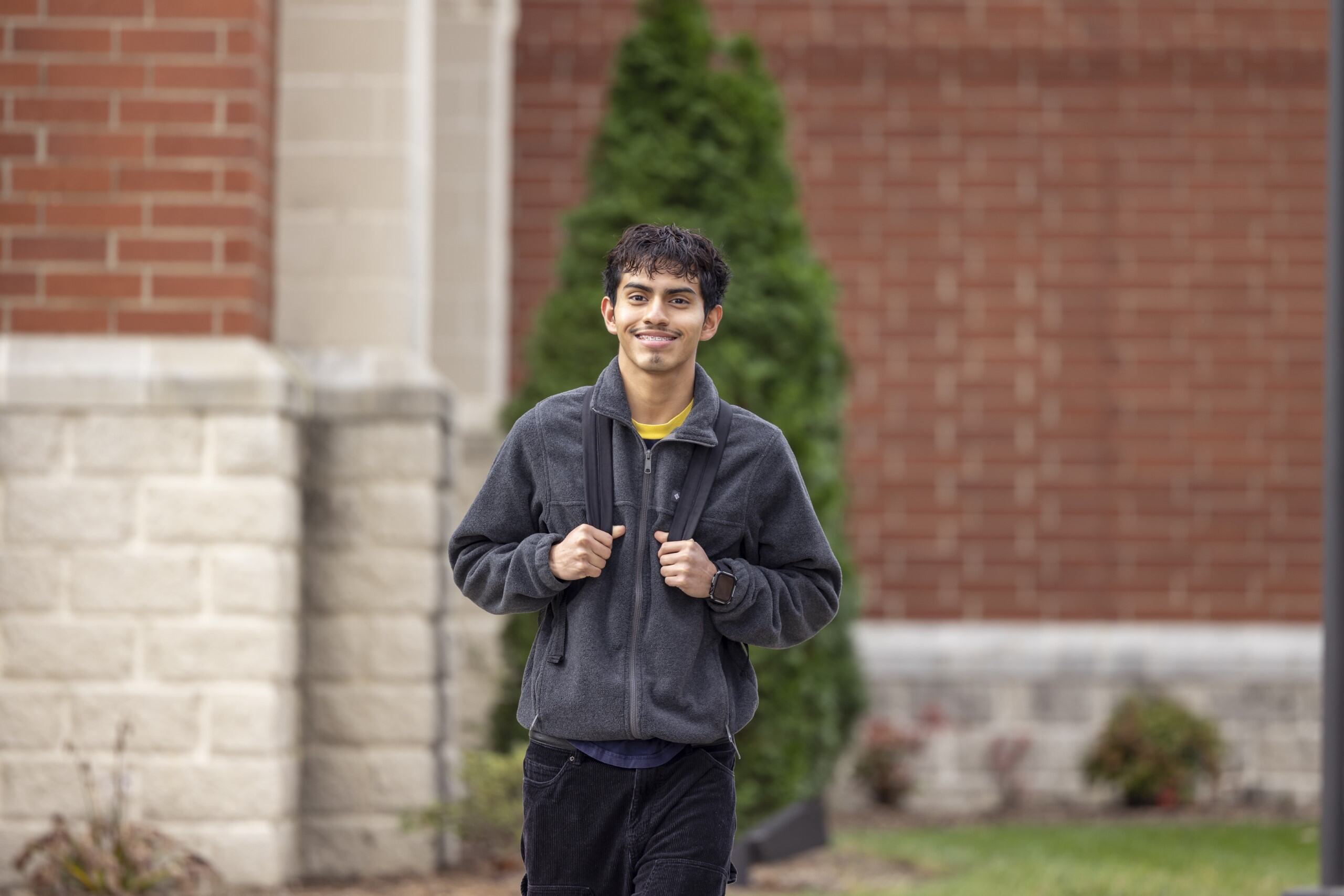 Student walking outside of the Main building.