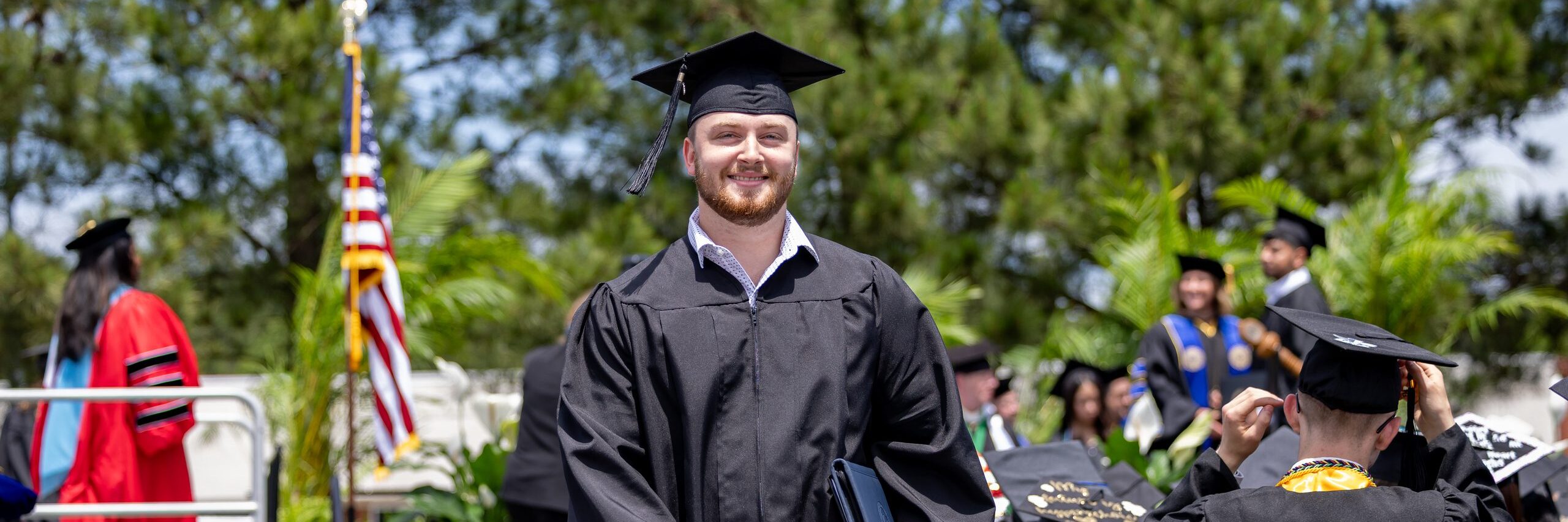 Student graduate walking back to his seat after receiving his degree.
