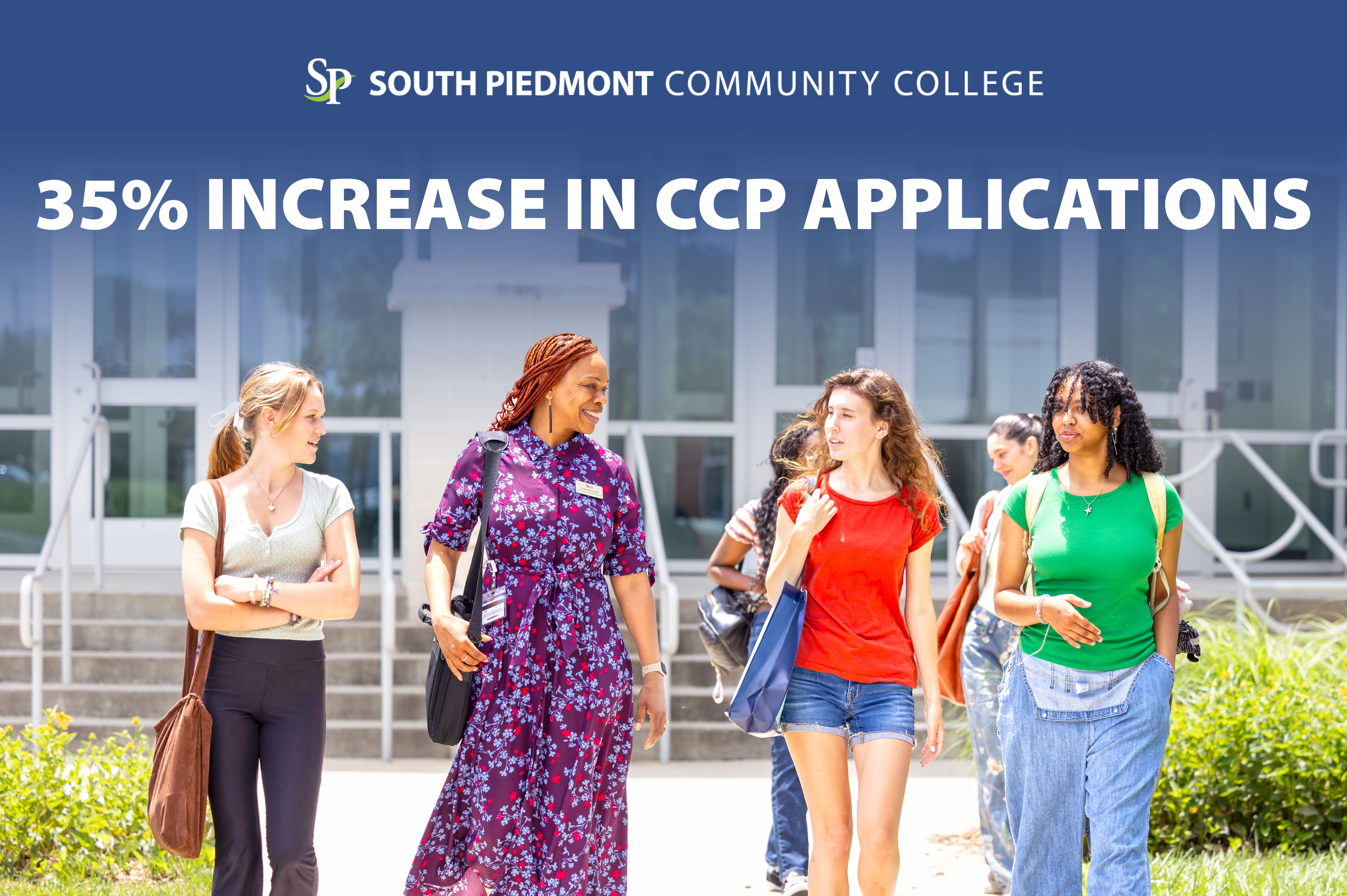Dr. Marsha Thomas, director secondary education, partnerships/academic affairs walking with students in front of the South Piedmont main building at the Old Charlotte Highway Campus.