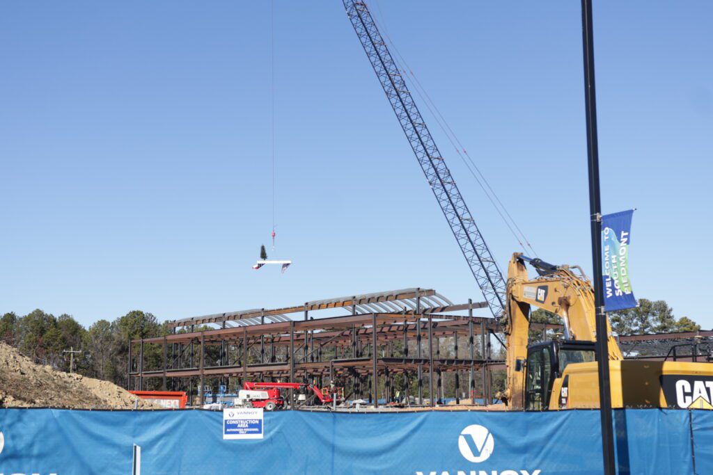 A crane hoisting a beam into position.