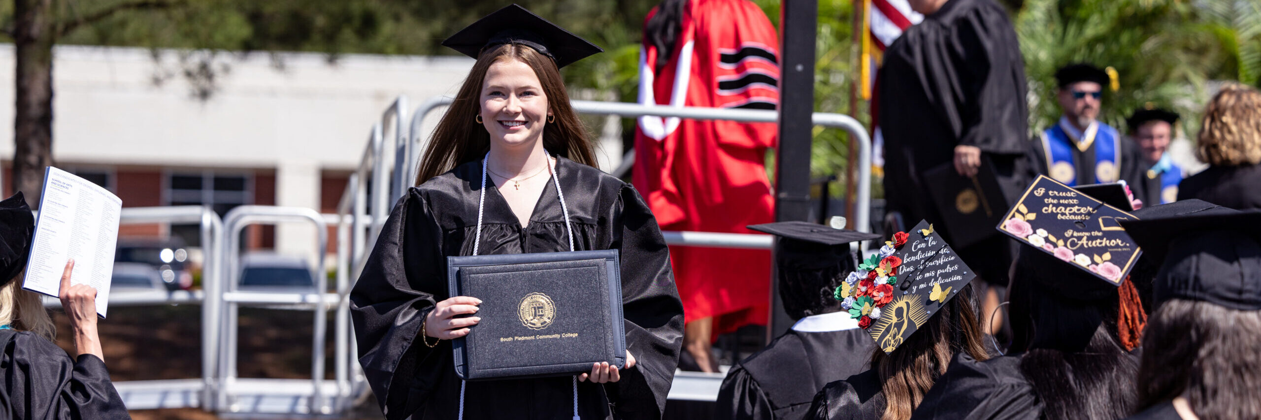 Student graduate walking back to her seat after receiving herdegree.