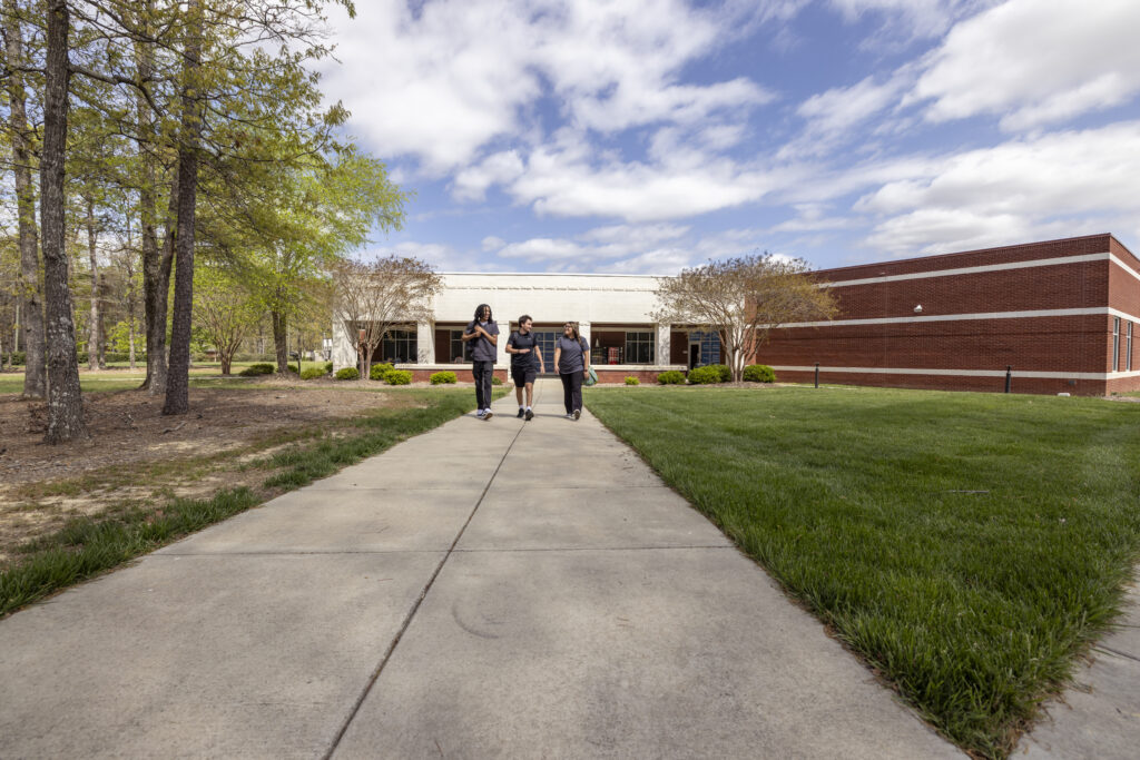 Three students walking outside of Braswell building at South Piedmont Community College.