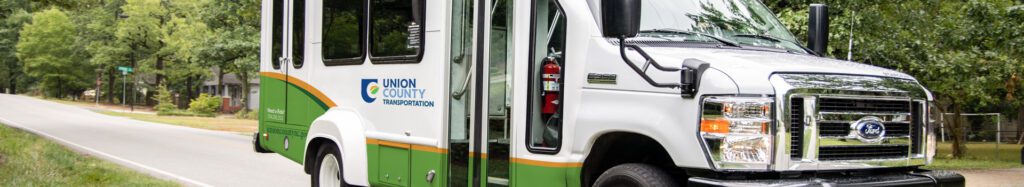 A wide, close up shot of Union County Transportation bus in action.