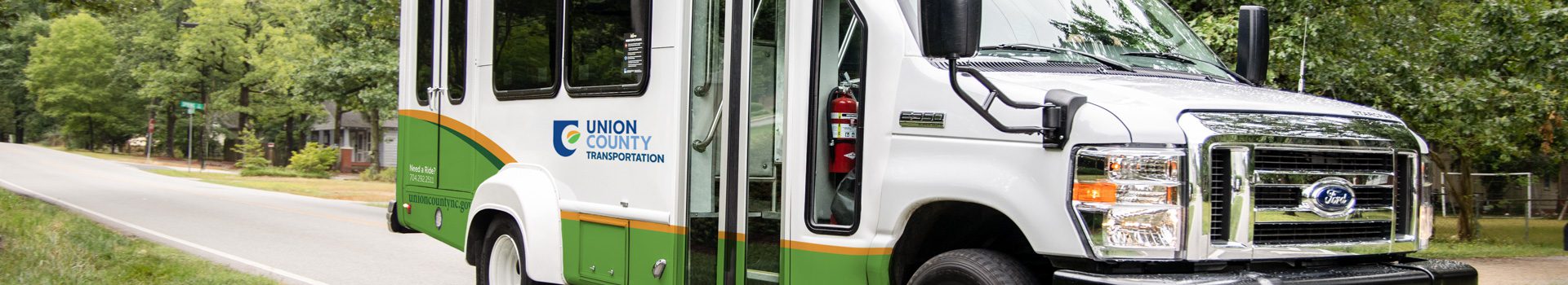 A wide, close up shot of Union County Transportation bus in action.