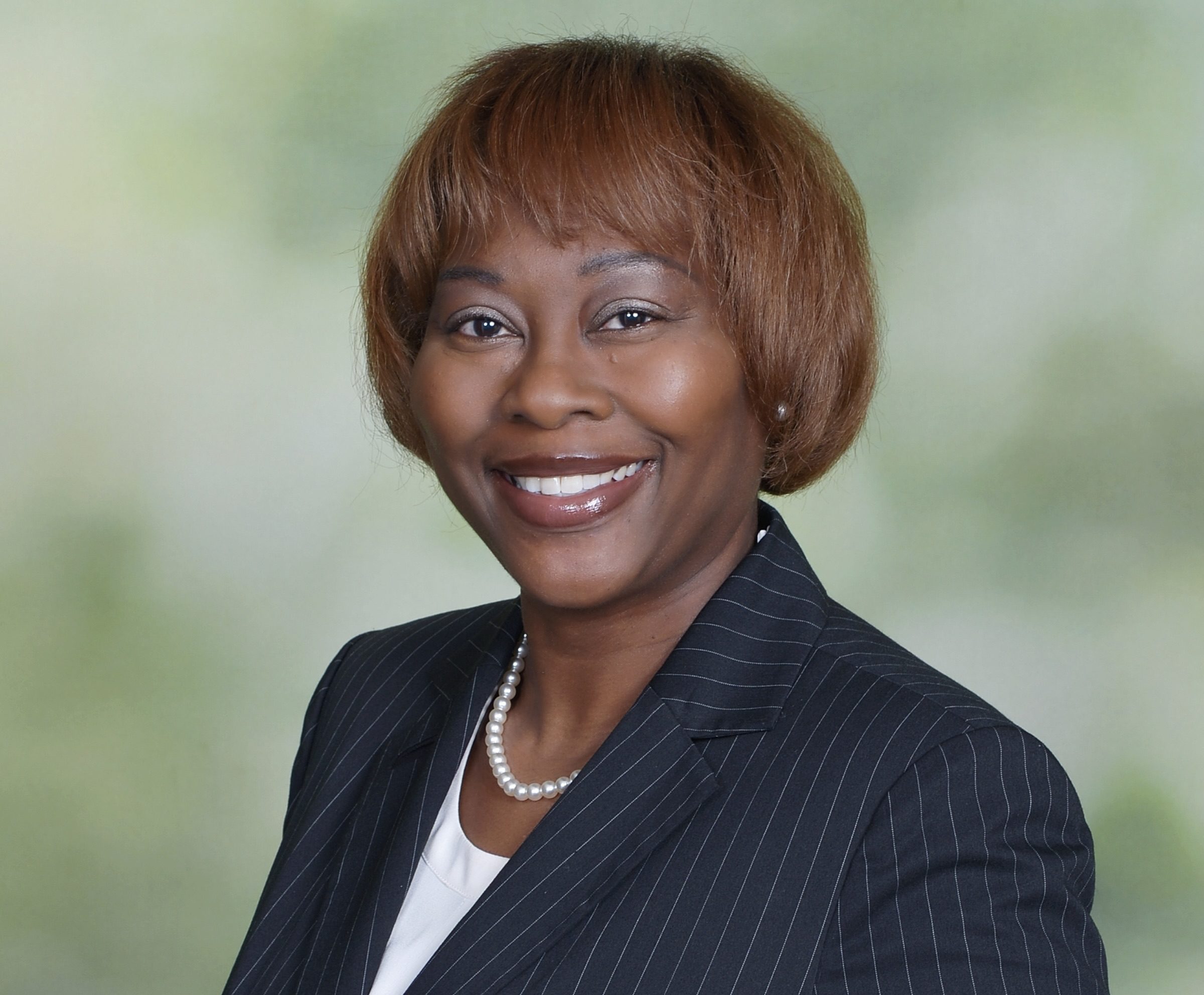 A photo of a woman in a navy blue suit.