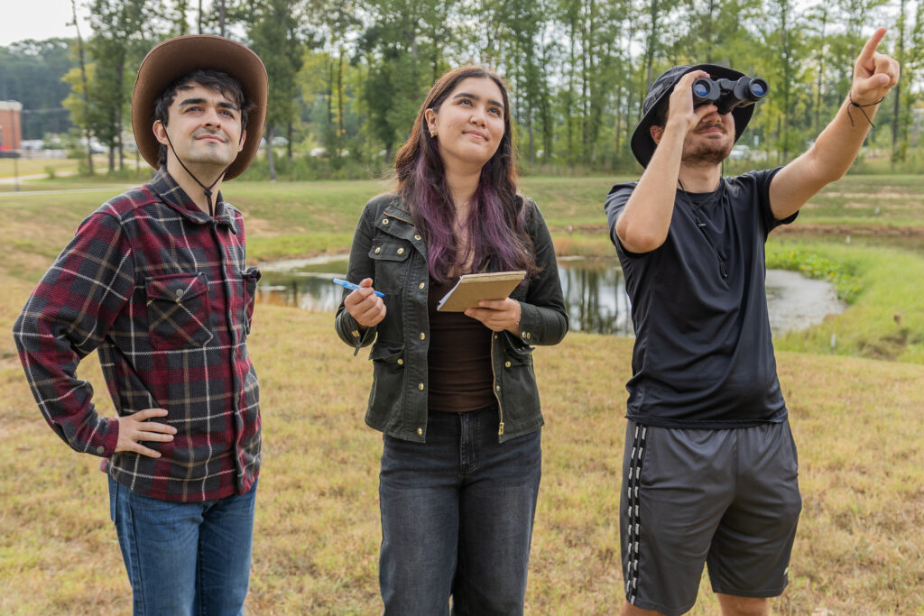 Three students participate in birdwatching around South Piedmont OCH campus.