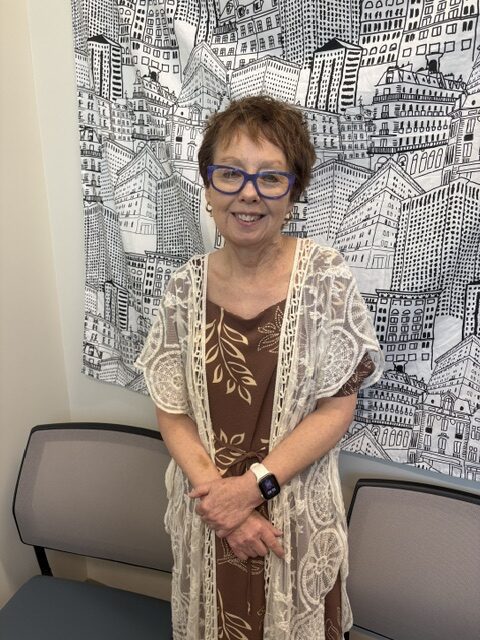 Tammy Frailly posing for the camera inside office.